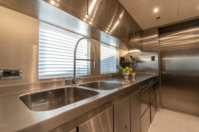 a kitchen with a sink and cabinets aboard LEONA Yacht for Sale
