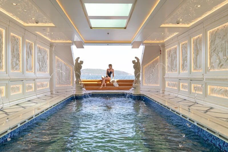 a person sitting on a bench in a pool aboard LEONA Yacht for Sale