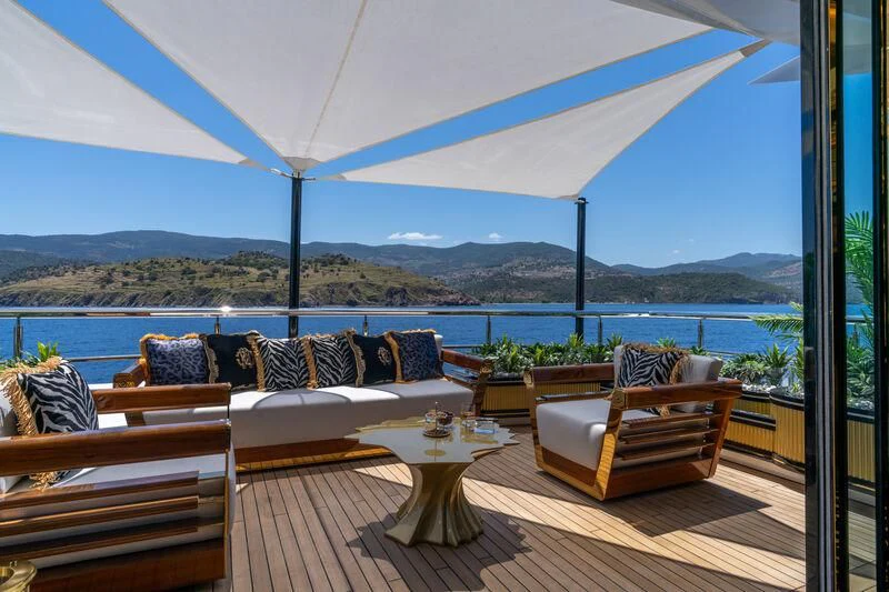 a patio with a table and chairs aboard LEONA Yacht for Sale