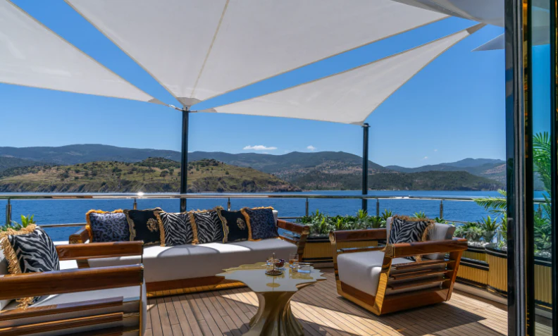 a patio with a table and chairs aboard LEONA Yacht for Sale