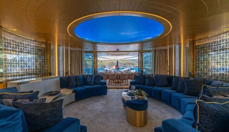 a large living room with a large window aboard LEONA Yacht for Sale