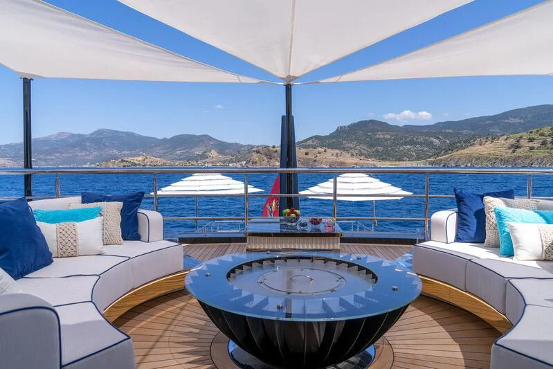 a large pool with a view of the mountains and the ocean aboard LEONA Yacht for Sale