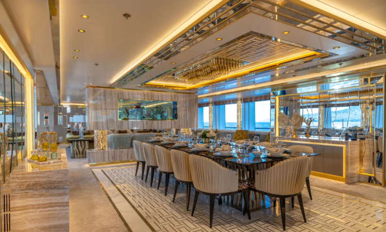 a large room with tables and chairs aboard LEONA Yacht for Sale