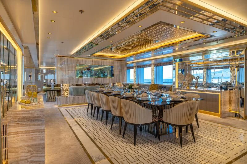 a room with a table and chairs aboard LEONA Yacht for Sale