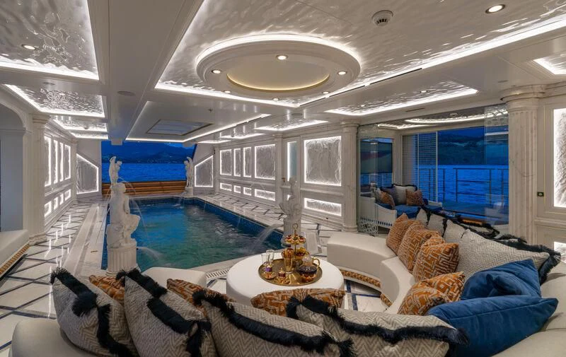 a large living room with a large swimming pool aboard LEONA Yacht for Sale