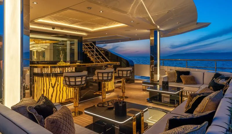 a room with a couch and a table and chairs aboard LEONA Yacht for Sale