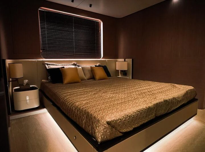 a bed with a black headboard aboard AZIMUT GRANDE 27/16 Yacht for Sale