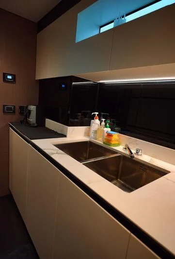 a kitchen with a sink and cabinets aboard AZIMUT GRANDE 27/16 Yacht for Sale