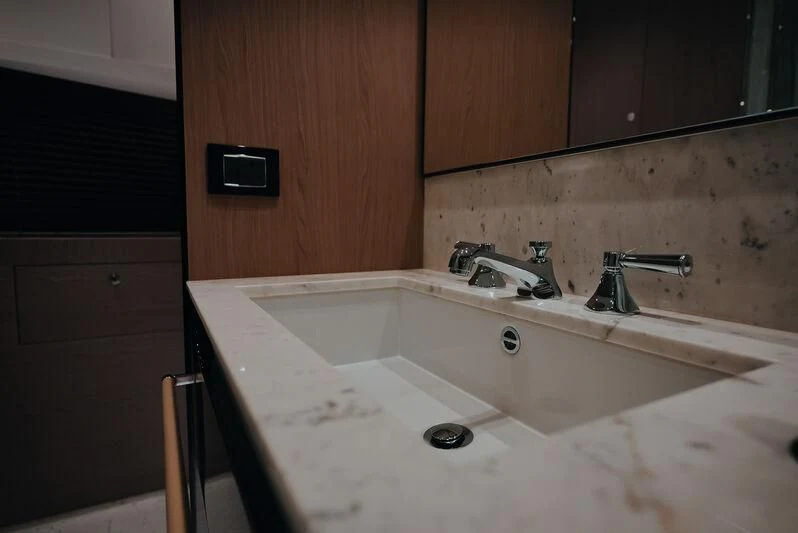 a bathroom with a sink and a faucet aboard AZIMUT GRANDE 27/16 Yacht for Sale