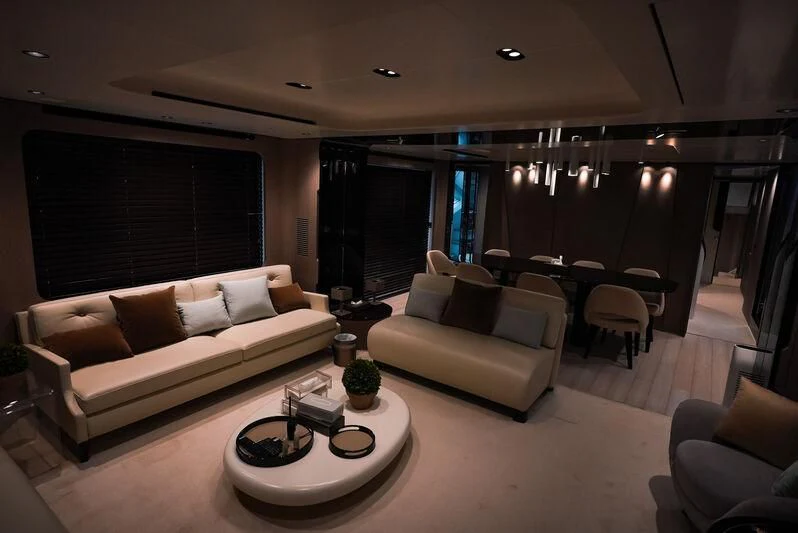 a living room with a couch and a table aboard AZIMUT GRANDE 27/16 Yacht for Sale