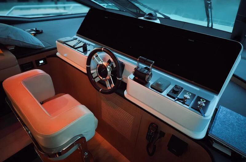 a wooden paneled panel with a speaker and a steering wheel aboard AZIMUT GRANDE 27/16 Yacht for Sale