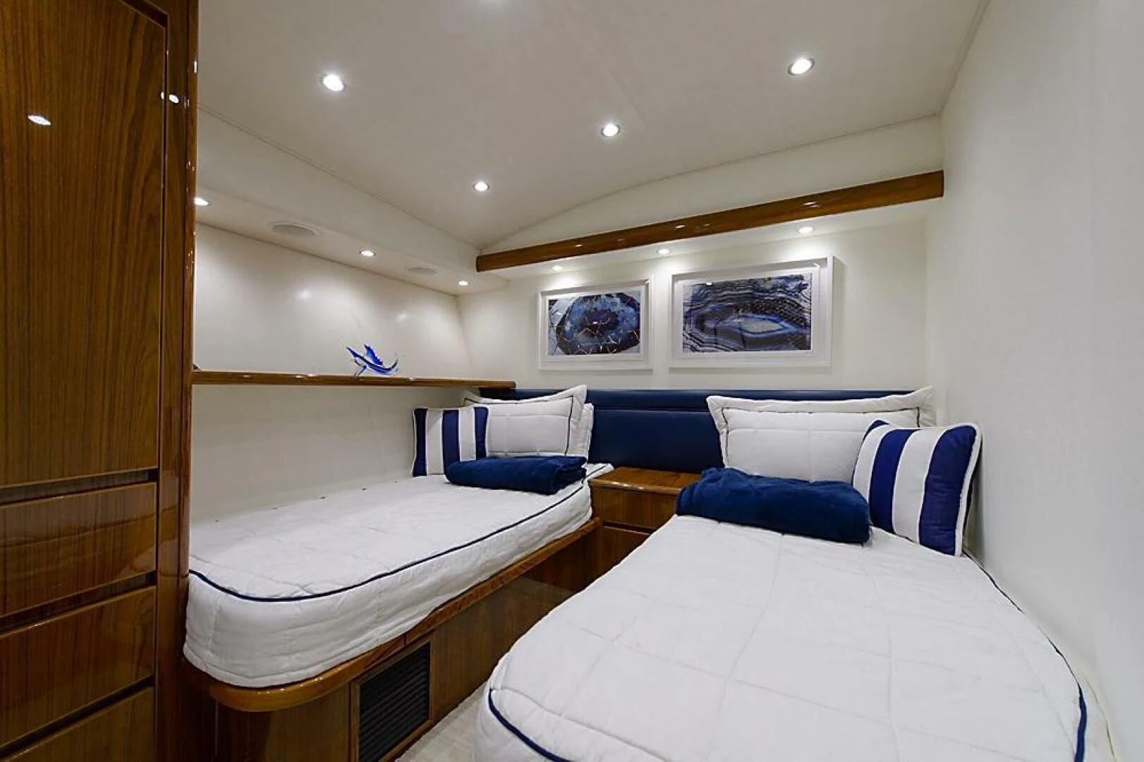 a room with a bed and a desk aboard INSTIGATOR Yacht for Sale