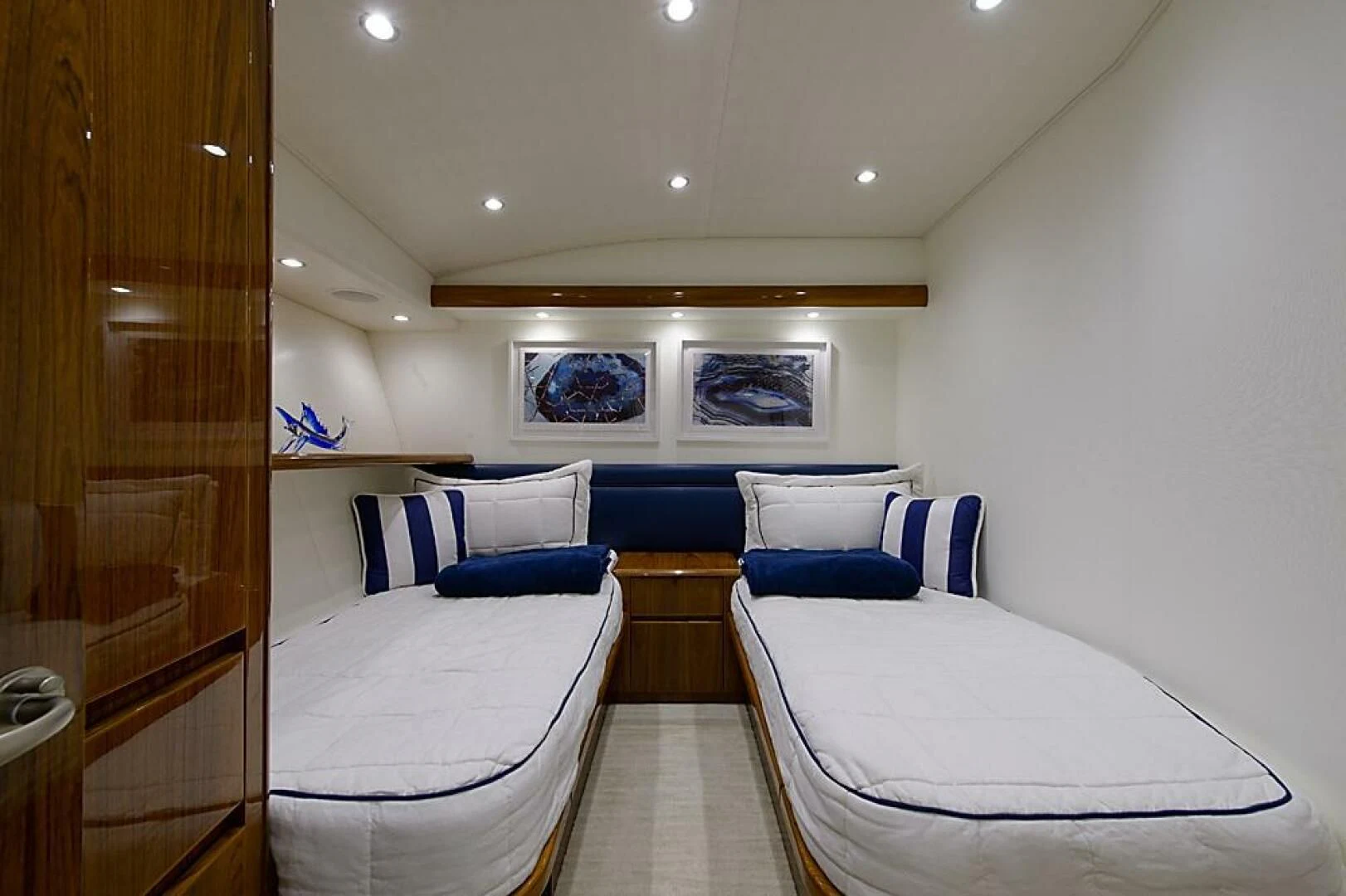 a room with a bed and a table aboard INSTIGATOR Yacht for Sale