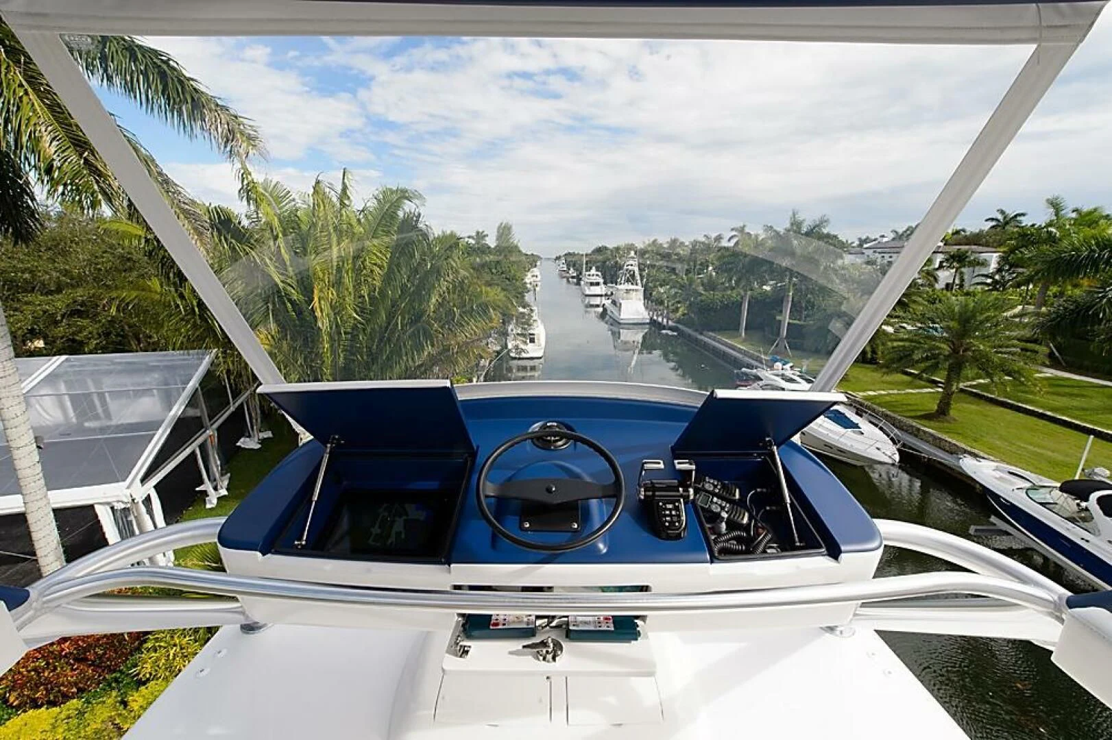 a white boat with a blue front aboard INSTIGATOR Yacht for Sale