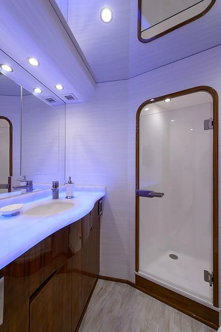 a bathroom with a large mirror aboard INSTIGATOR Yacht for Sale