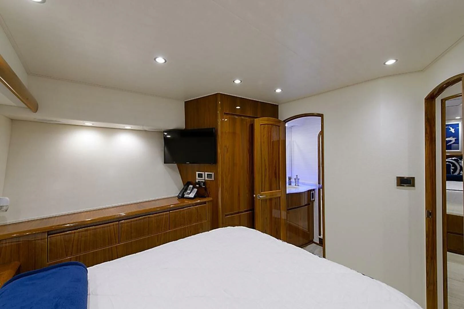 a bedroom with a bed and a television aboard INSTIGATOR Yacht for Sale