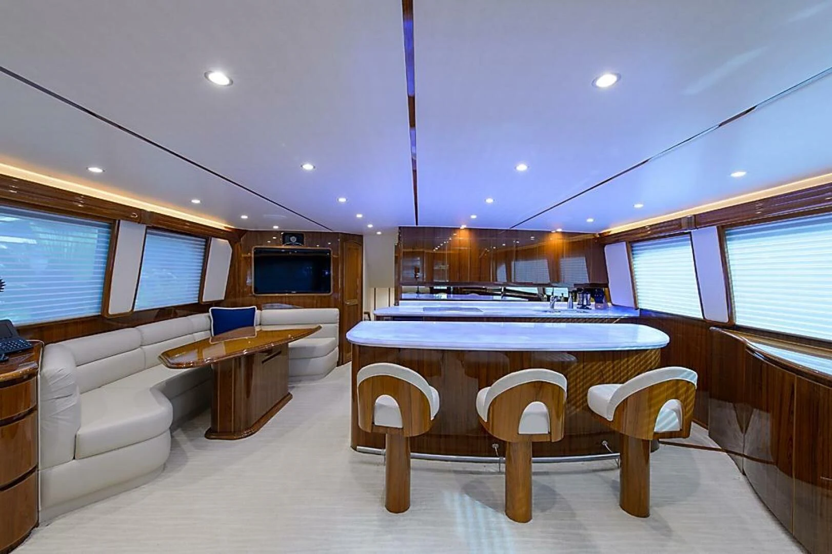 a large room with a table and chairs aboard INSTIGATOR Yacht for Sale