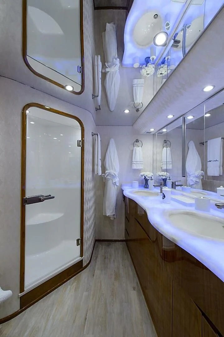 a bathroom with a large mirror aboard INSTIGATOR Yacht for Sale