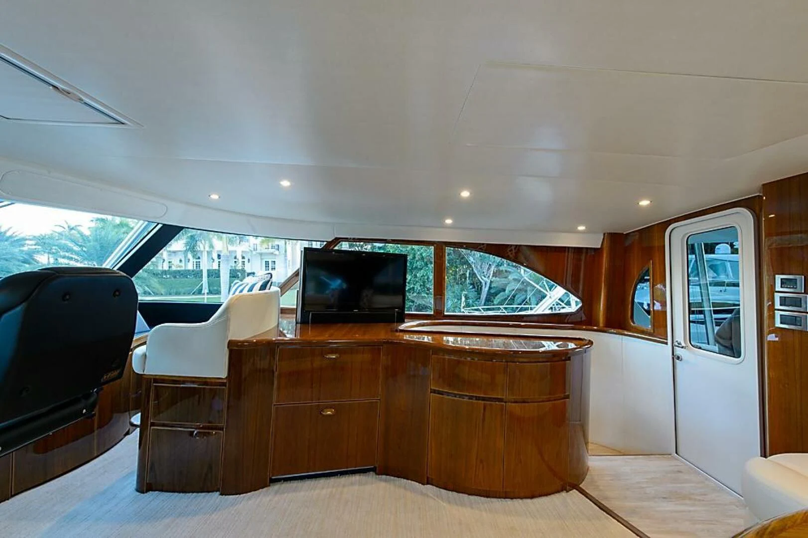 a living room with a tv and furniture aboard INSTIGATOR Yacht for Sale
