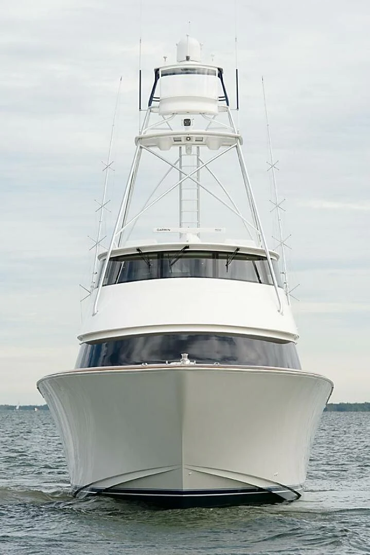 a white boat in the water aboard INSTIGATOR Yacht for Sale