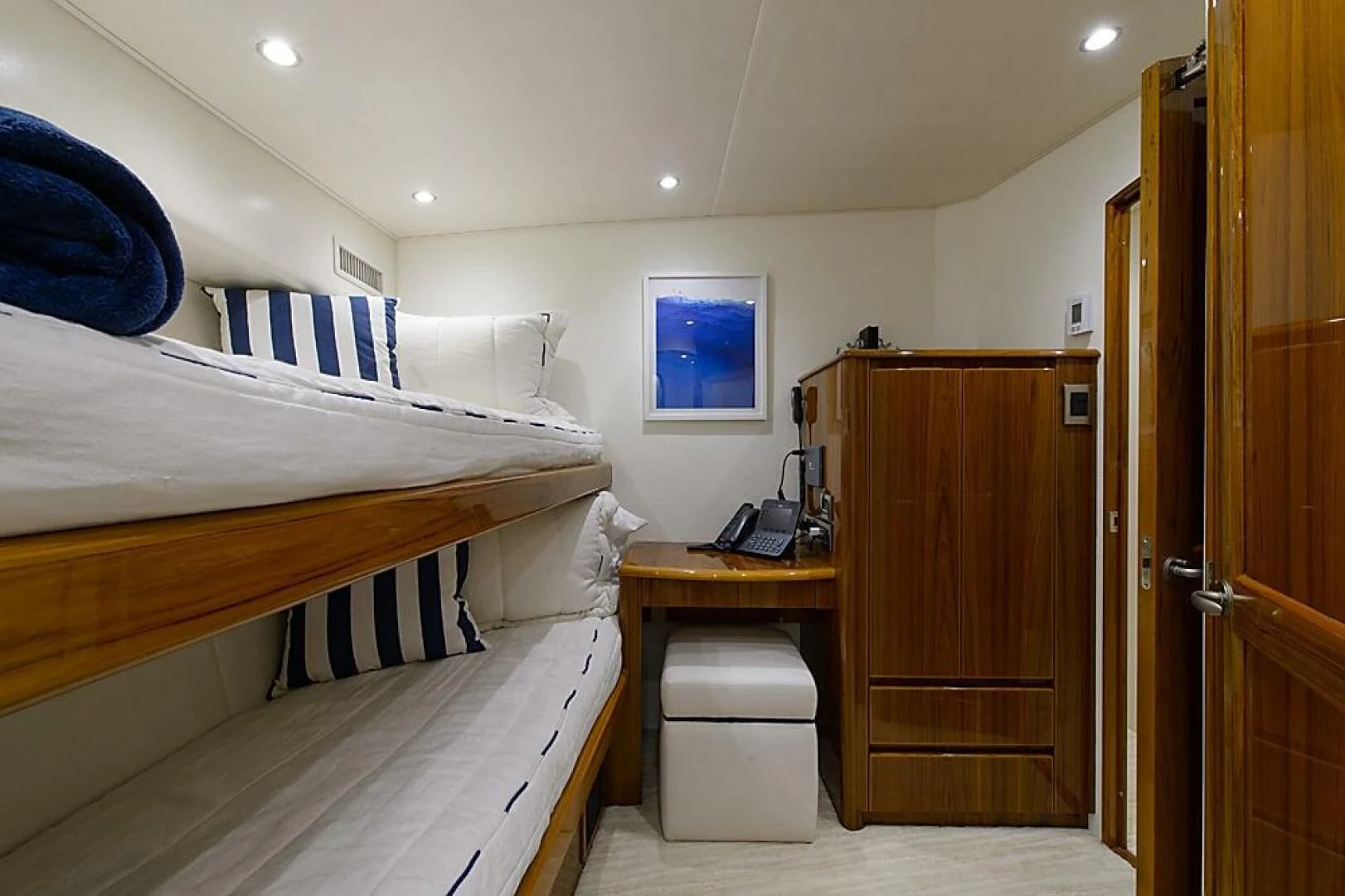 a room with a bed and desk aboard INSTIGATOR Yacht for Sale