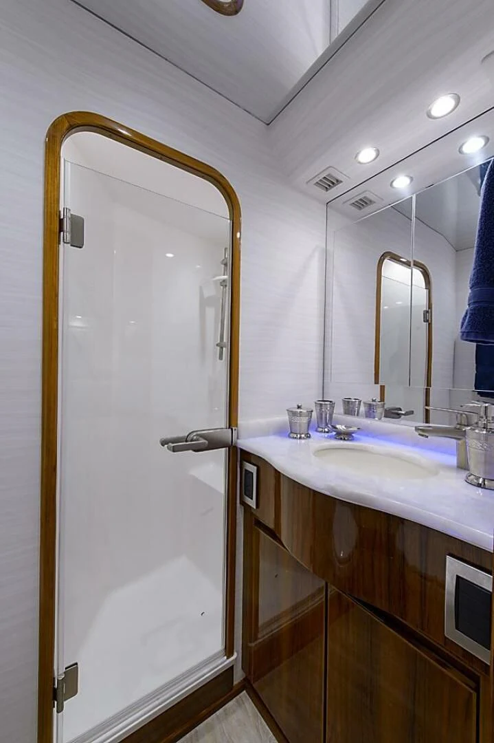 a bathroom with a sink and a mirror aboard INSTIGATOR Yacht for Sale