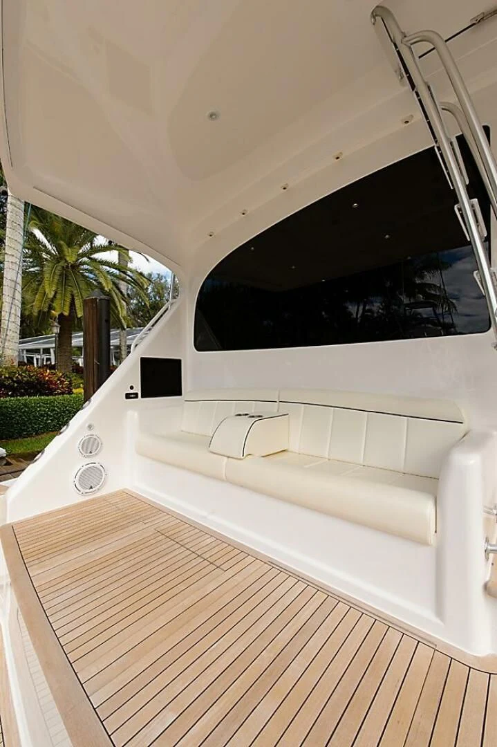 a white car with a flat screen aboard INSTIGATOR Yacht for Sale