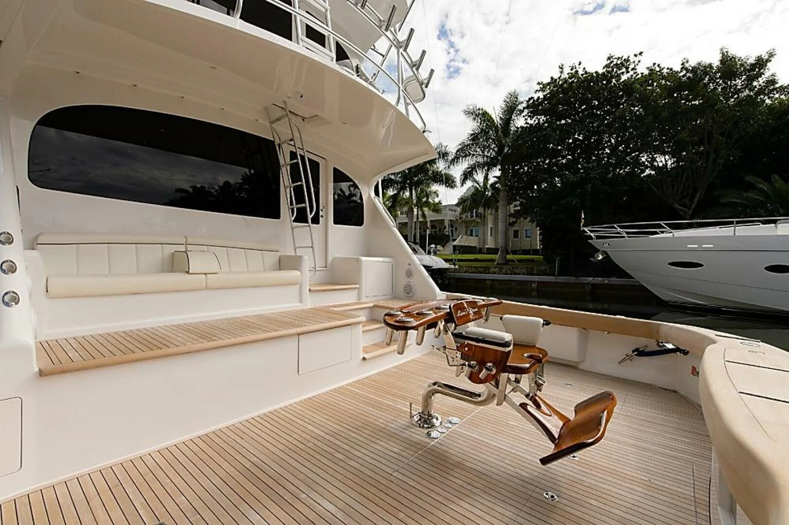 a room with a deck and chairs aboard INSTIGATOR Yacht for Sale