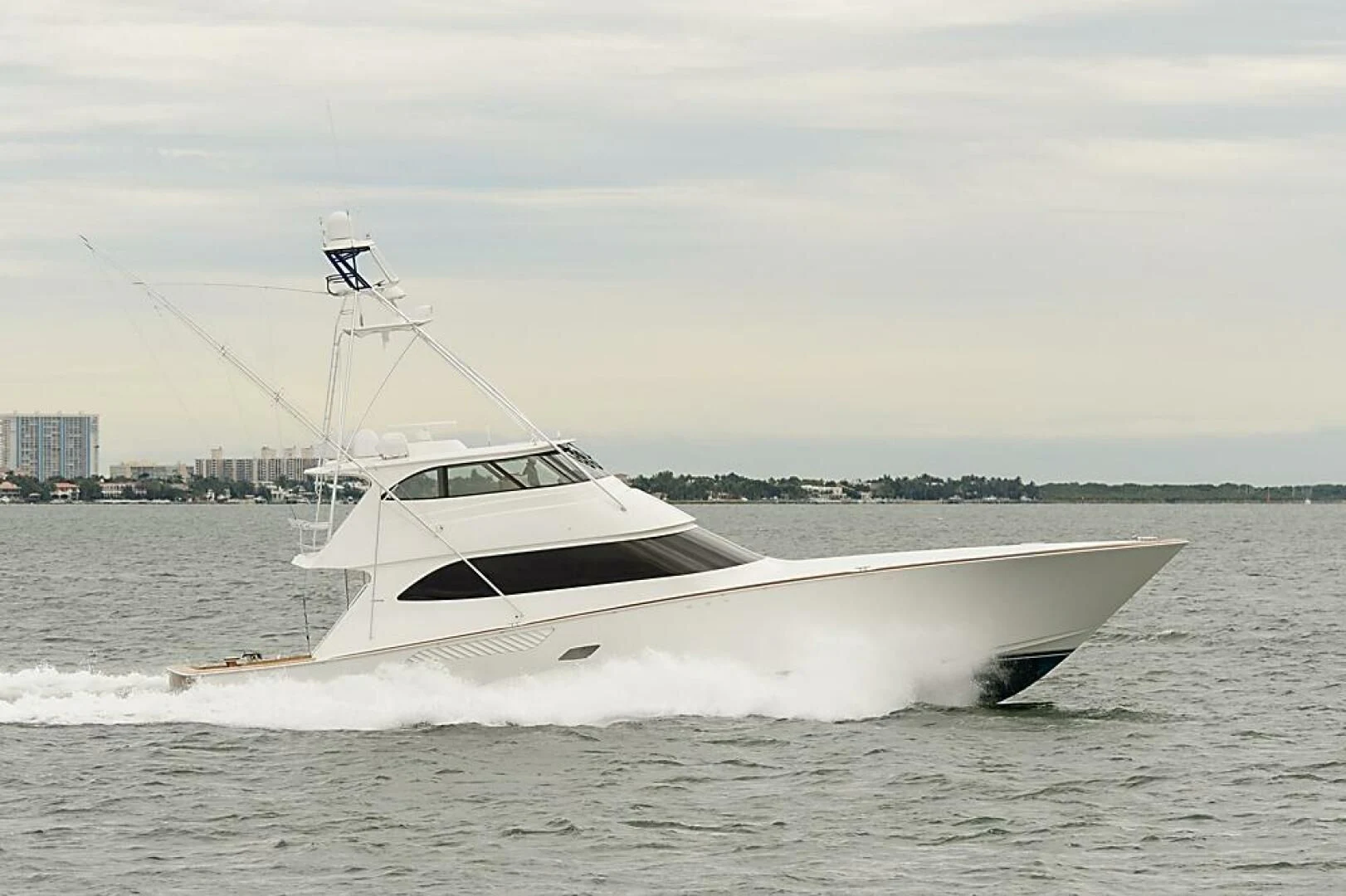 a white boat in the water aboard INSTIGATOR Yacht for Sale