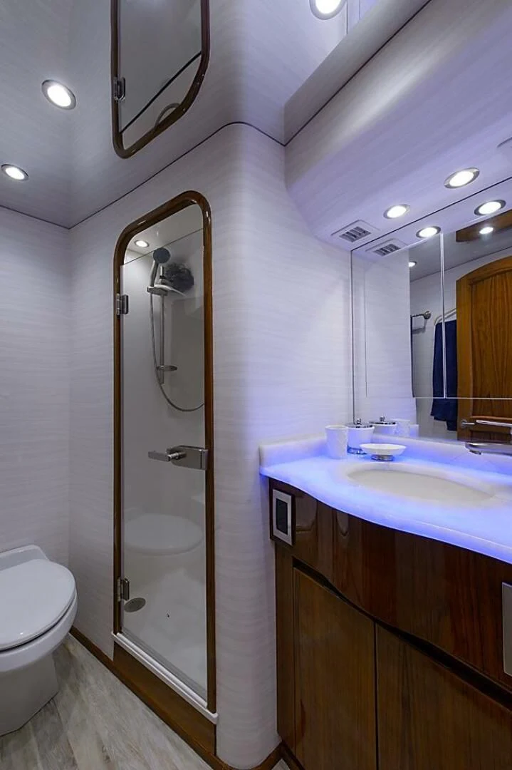 a bathroom with a glass shower door aboard INSTIGATOR Yacht for Sale