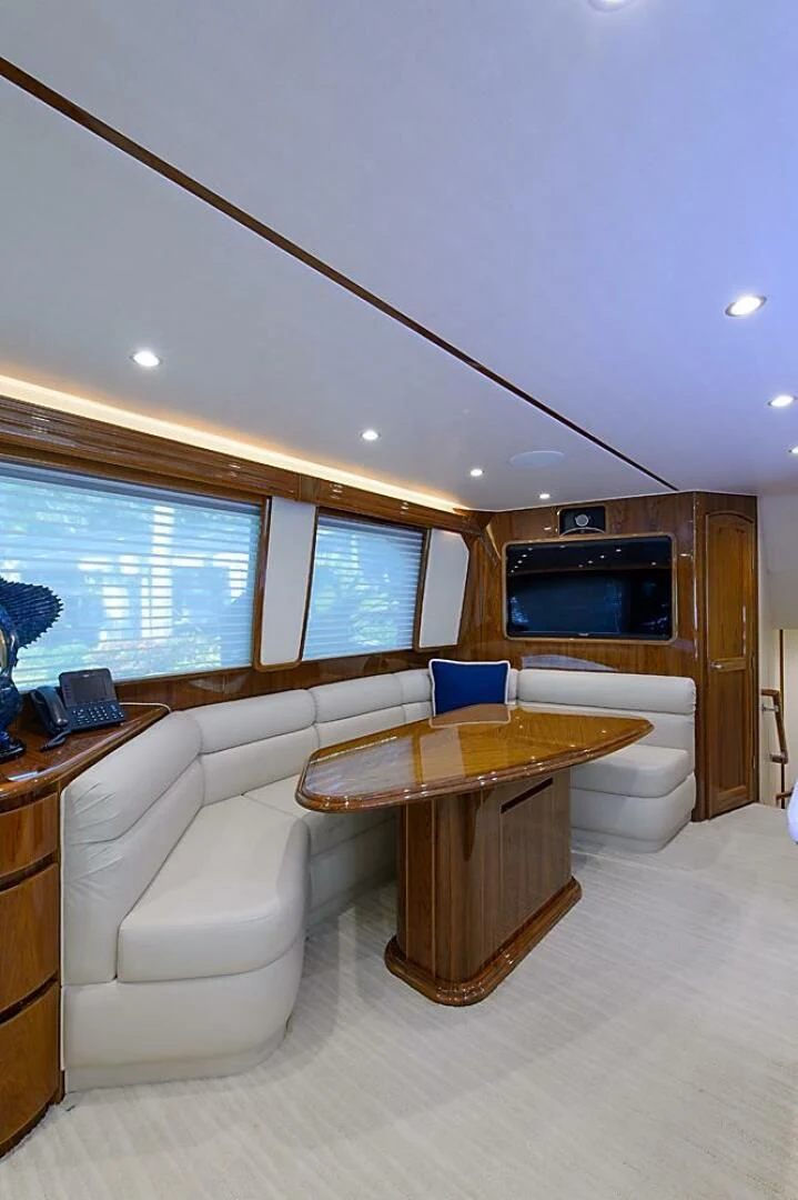 a room with a table and a couch aboard INSTIGATOR Yacht for Sale
