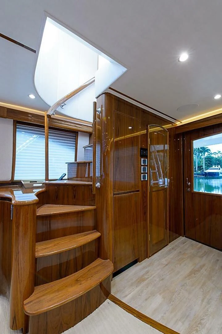 a room with a wood door and a wood bench aboard INSTIGATOR Yacht for Sale