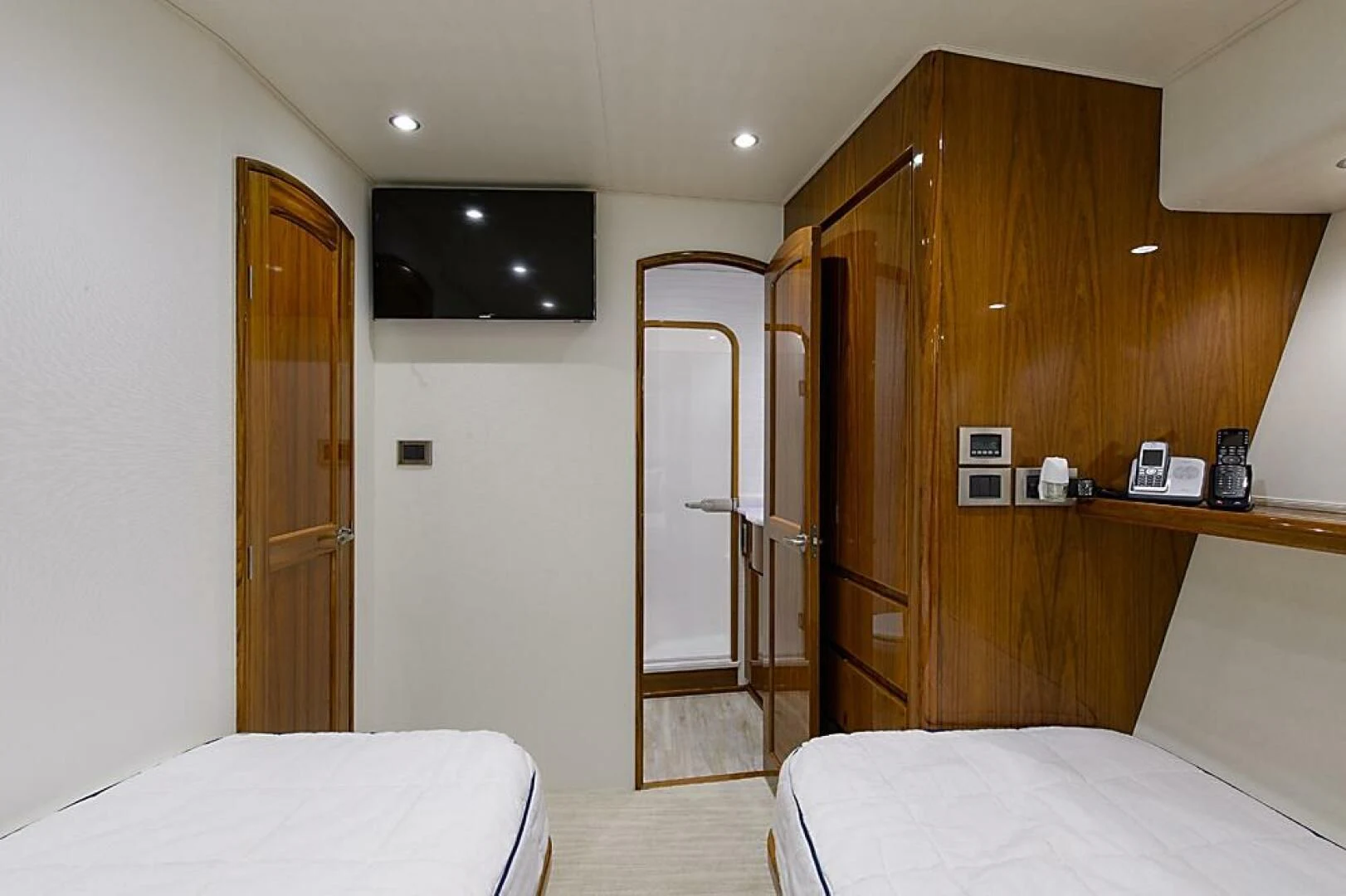 a room with a bed and a television aboard INSTIGATOR Yacht for Sale