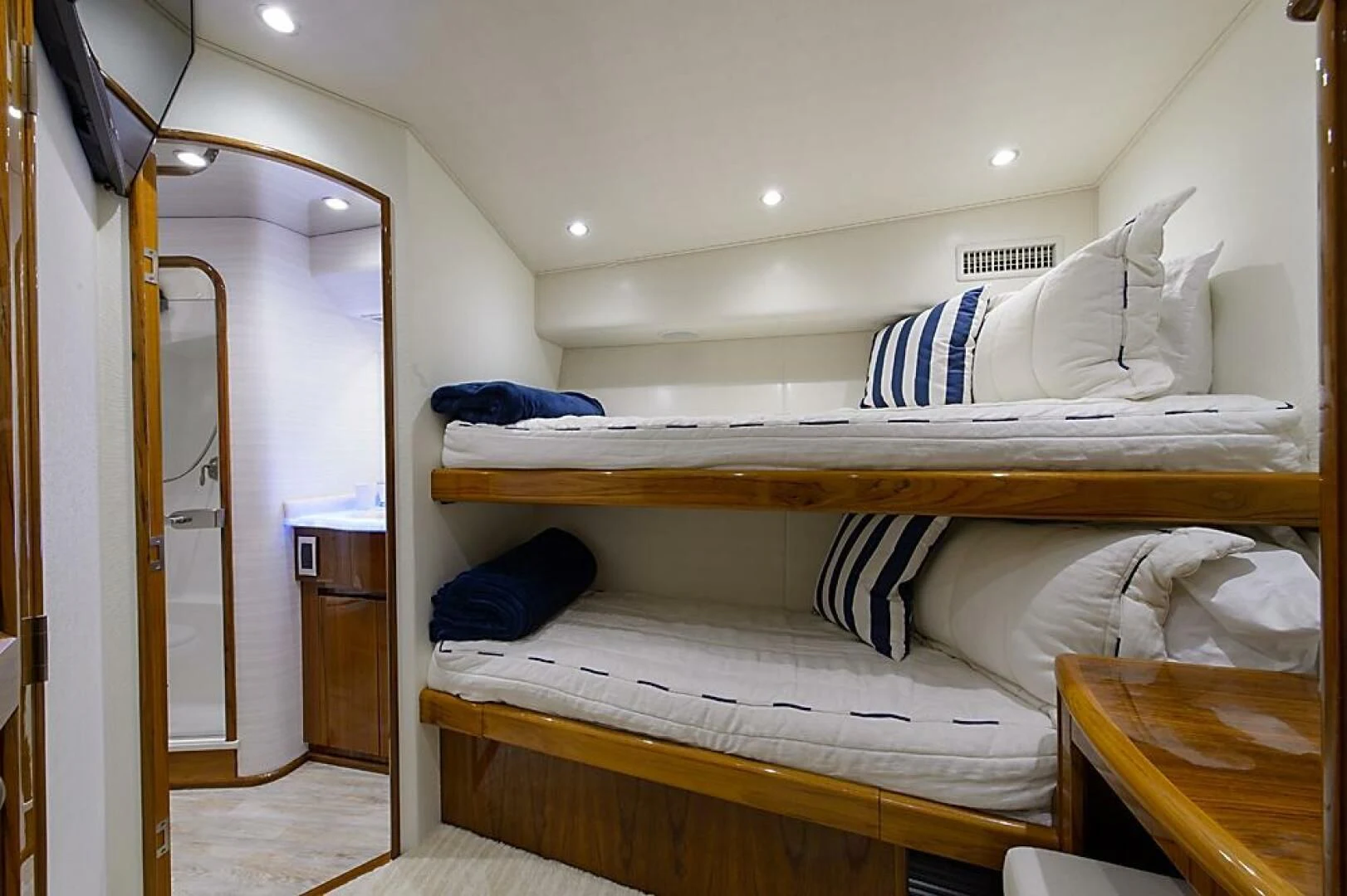 a room with beds and a desk aboard INSTIGATOR Yacht for Sale
