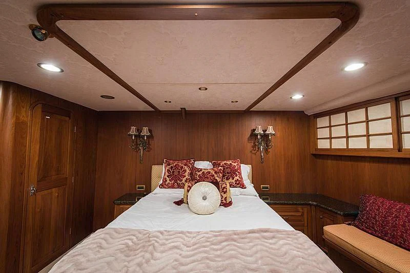 a bed with a stuffed animal on it aboard CASABELLA Yacht for Sale