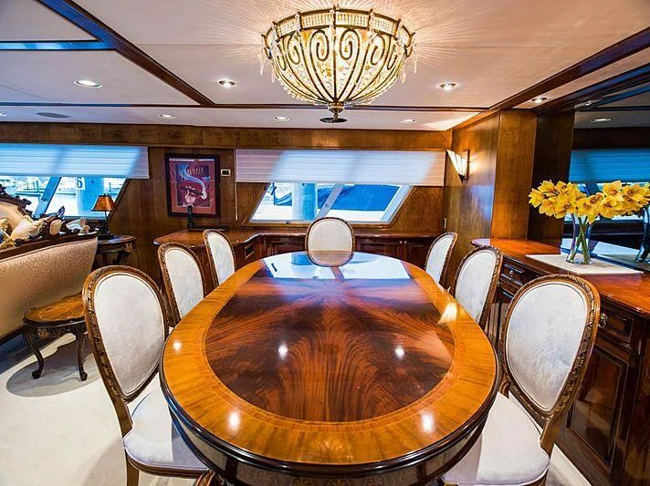 a room with a round table and chairs and a chandelier aboard CASABELLA Yacht for Sale