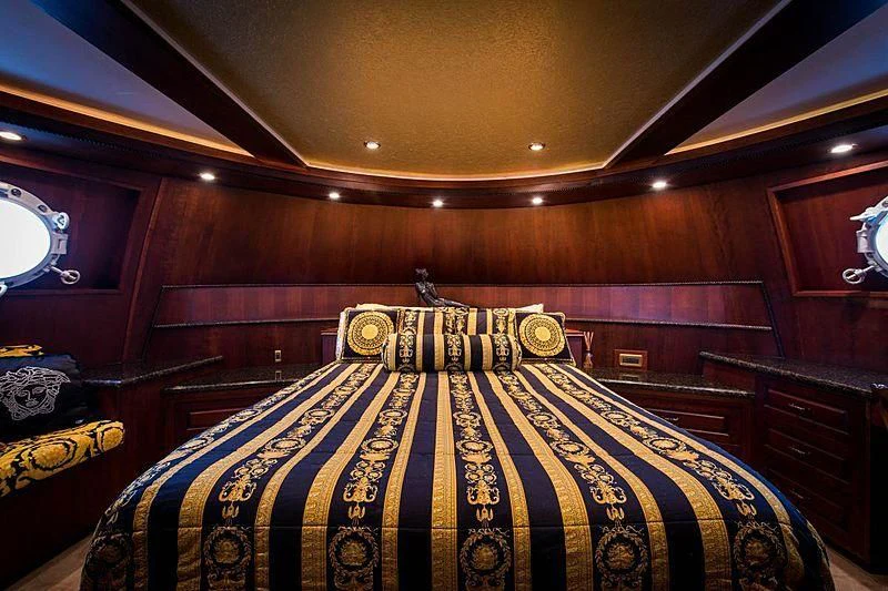 a bed with a black and white sheet and a black and gold bed spread aboard CASABELLA Yacht for Sale
