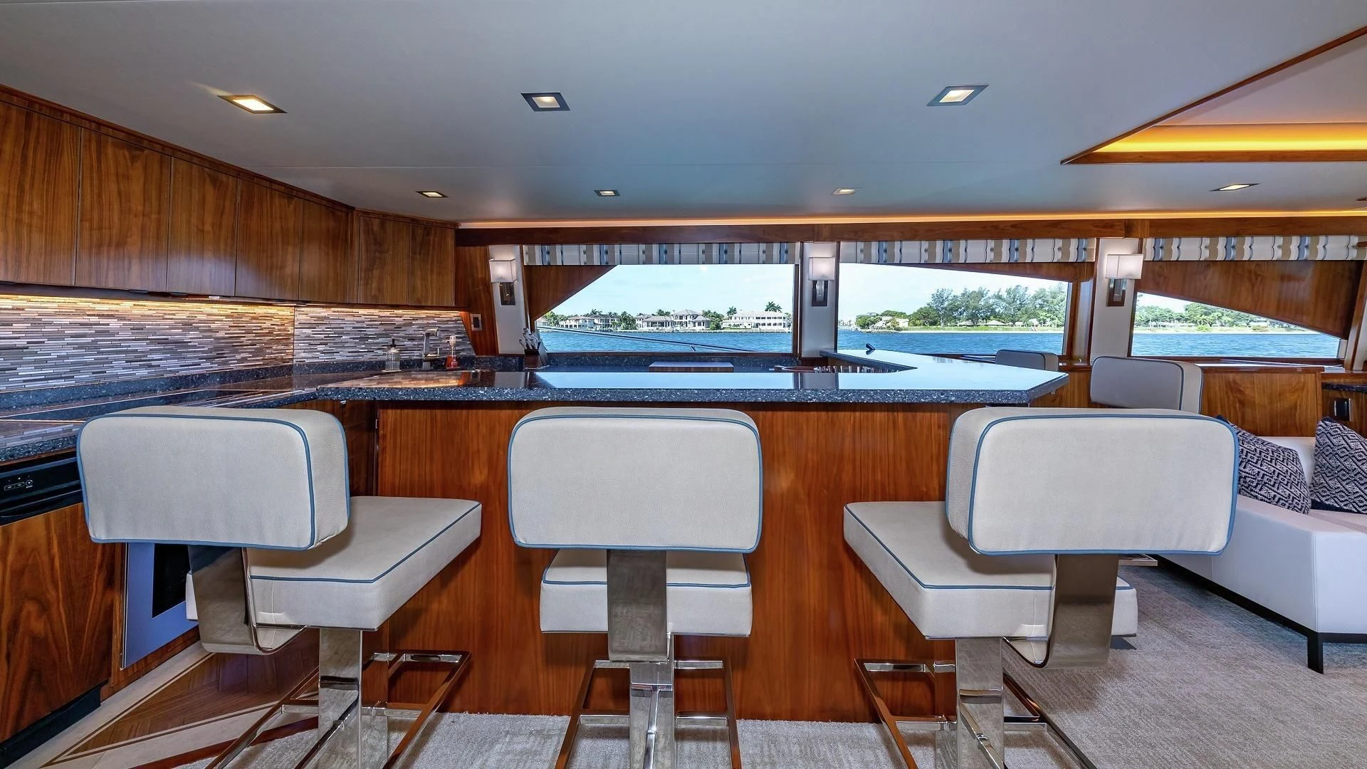 a large kitchen with a bar and chairs aboard AUSSIE RULES Yacht for Sale
