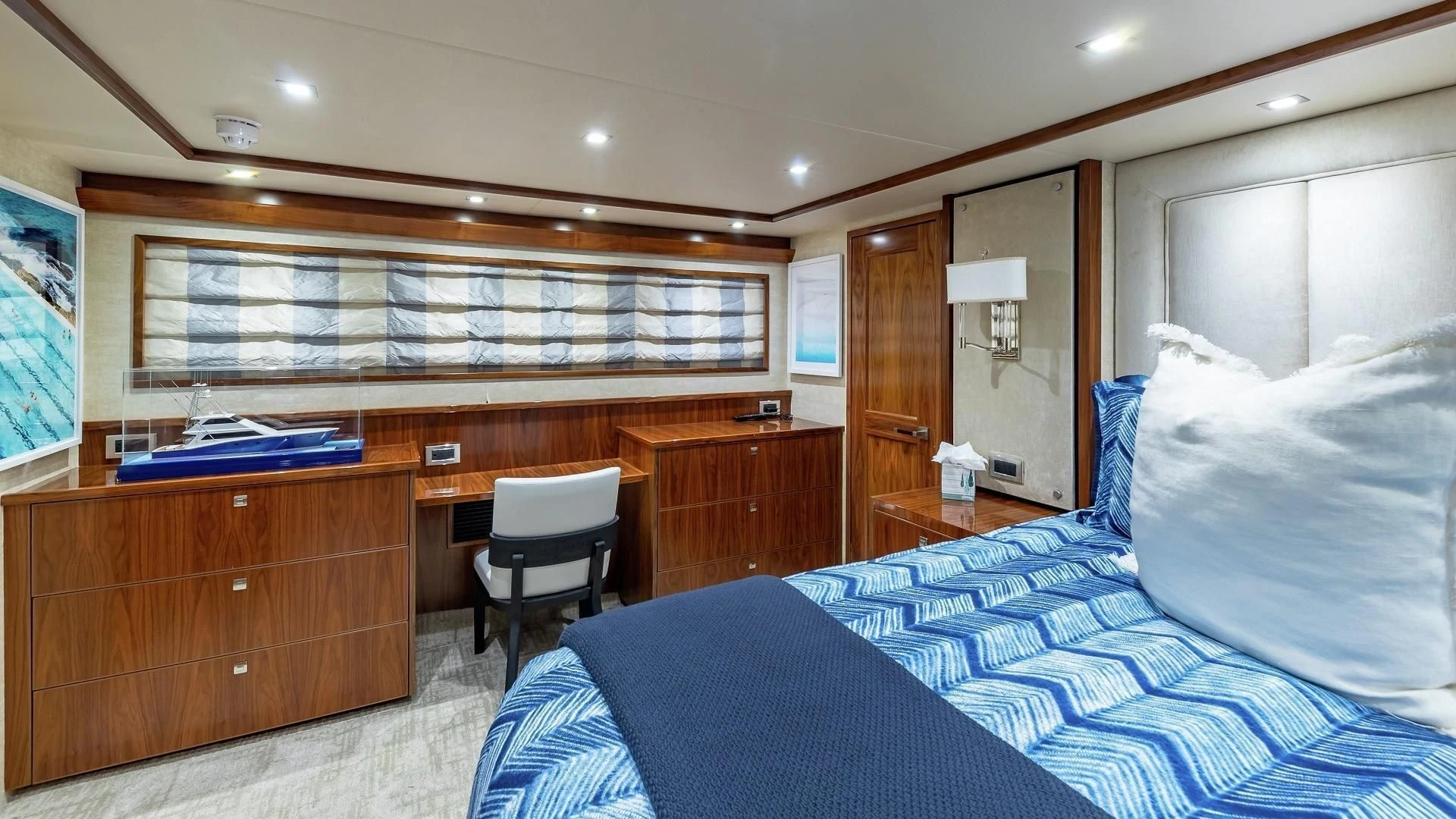 a bedroom with a bed and desk aboard AUSSIE RULES Yacht for Sale