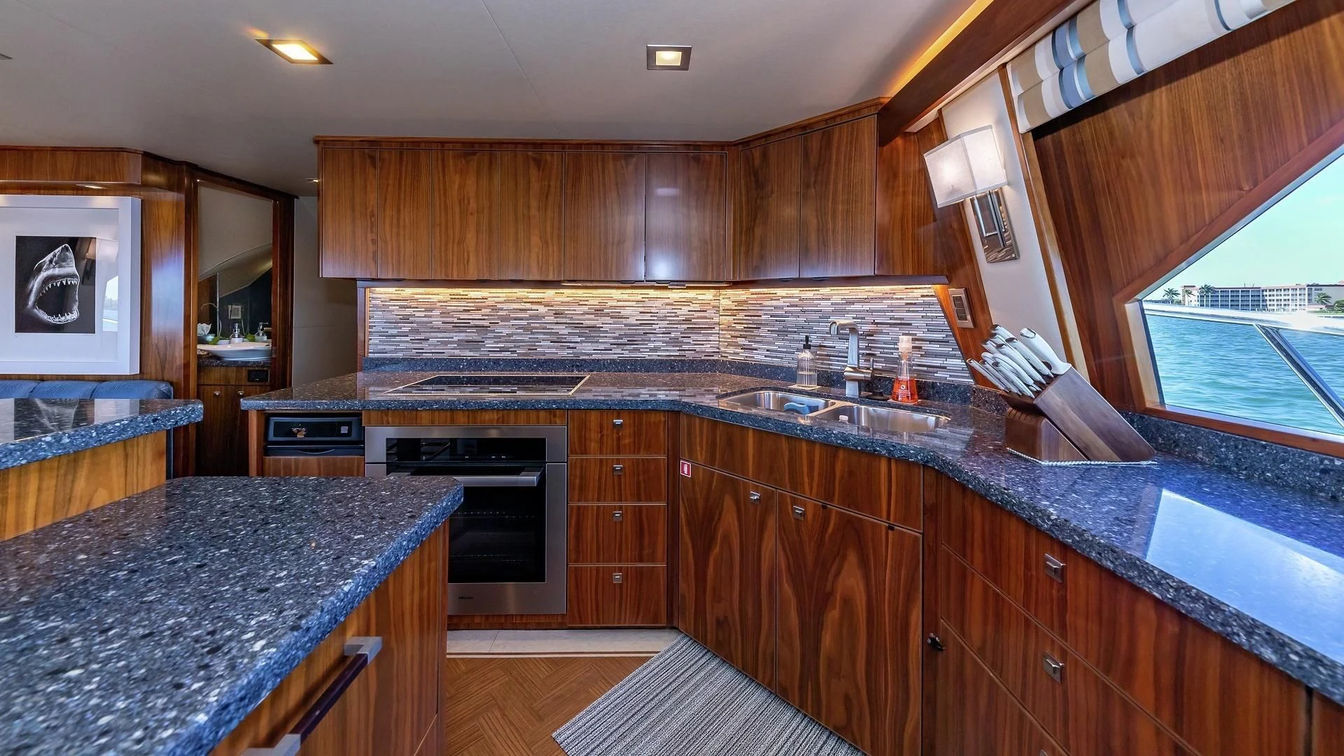 a kitchen with wooden cabinets aboard AUSSIE RULES Yacht for Sale