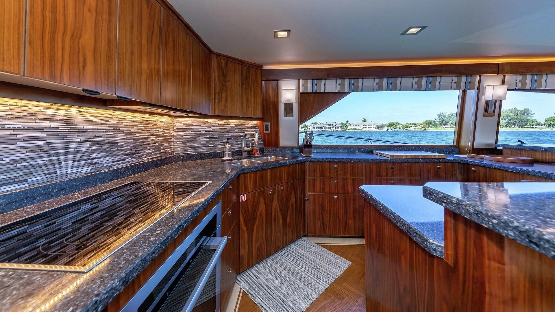 a large kitchen with wooden cabinets aboard AUSSIE RULES Yacht for Sale
