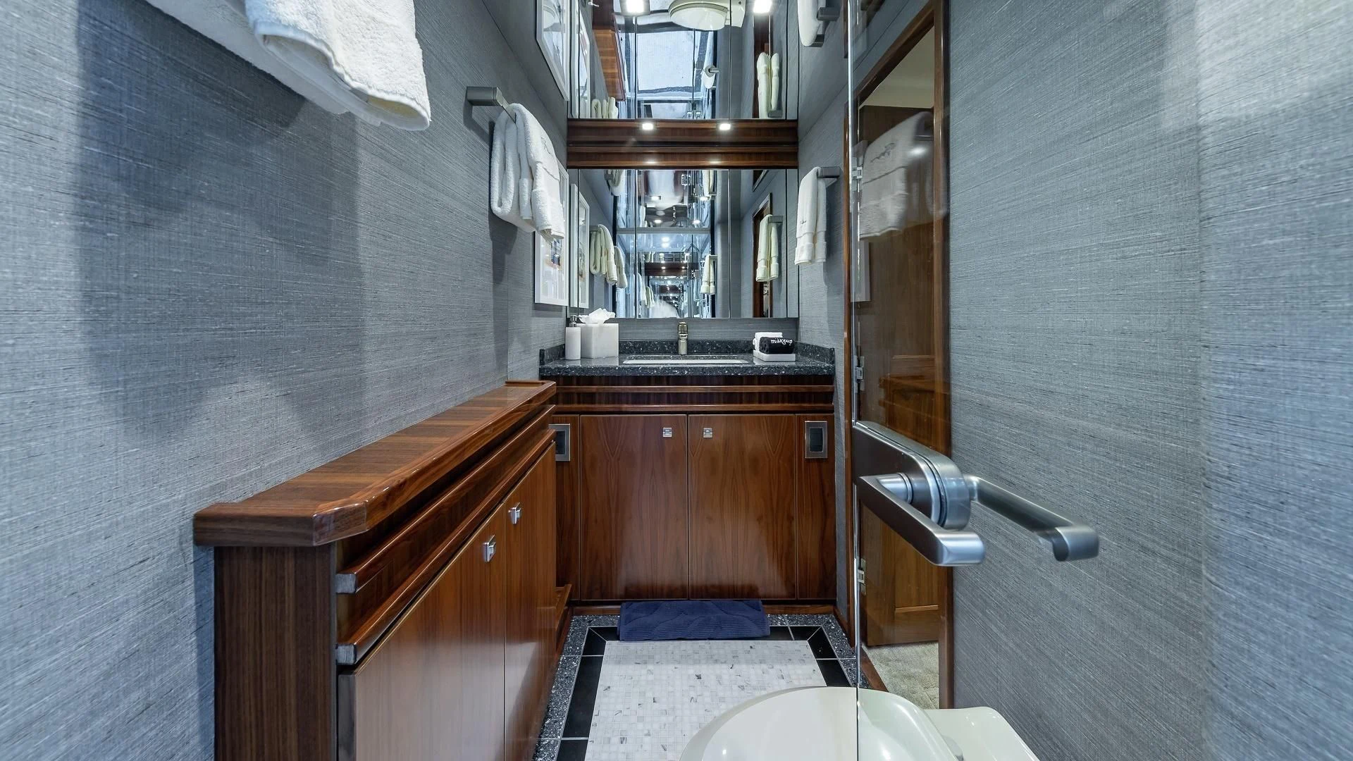 a bathroom with a sink and a mirror aboard AUSSIE RULES Yacht for Sale