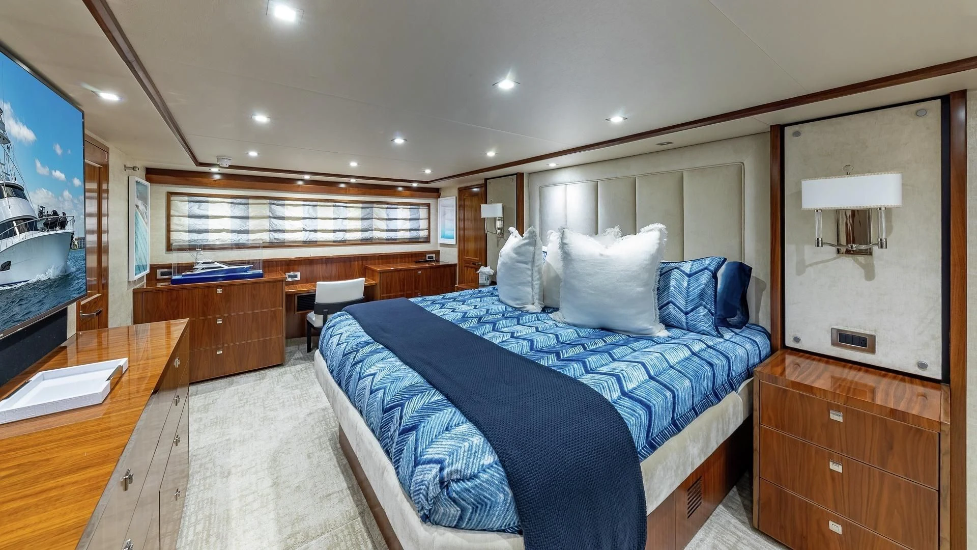 a bedroom with a bed and a mirror aboard AUSSIE RULES Yacht for Sale