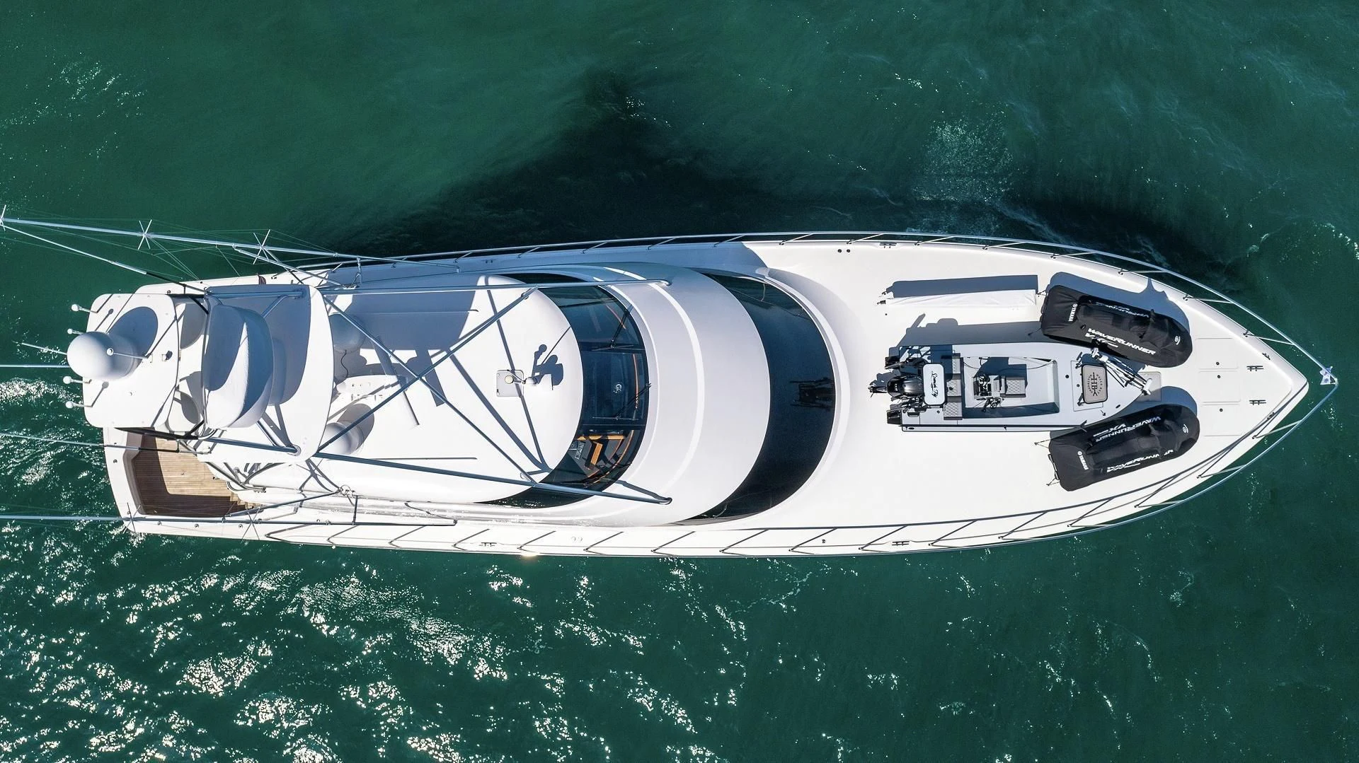 a white sports car with a blue stripe on the front aboard AUSSIE RULES Yacht for Sale