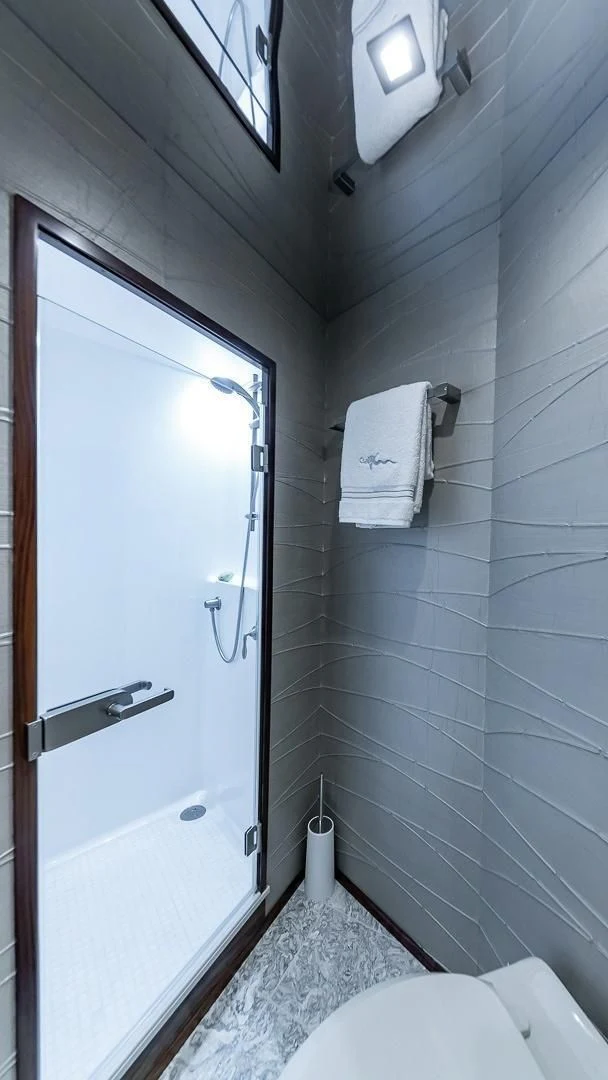 a bathroom with a toilet and a shower aboard AUSSIE RULES Yacht for Sale