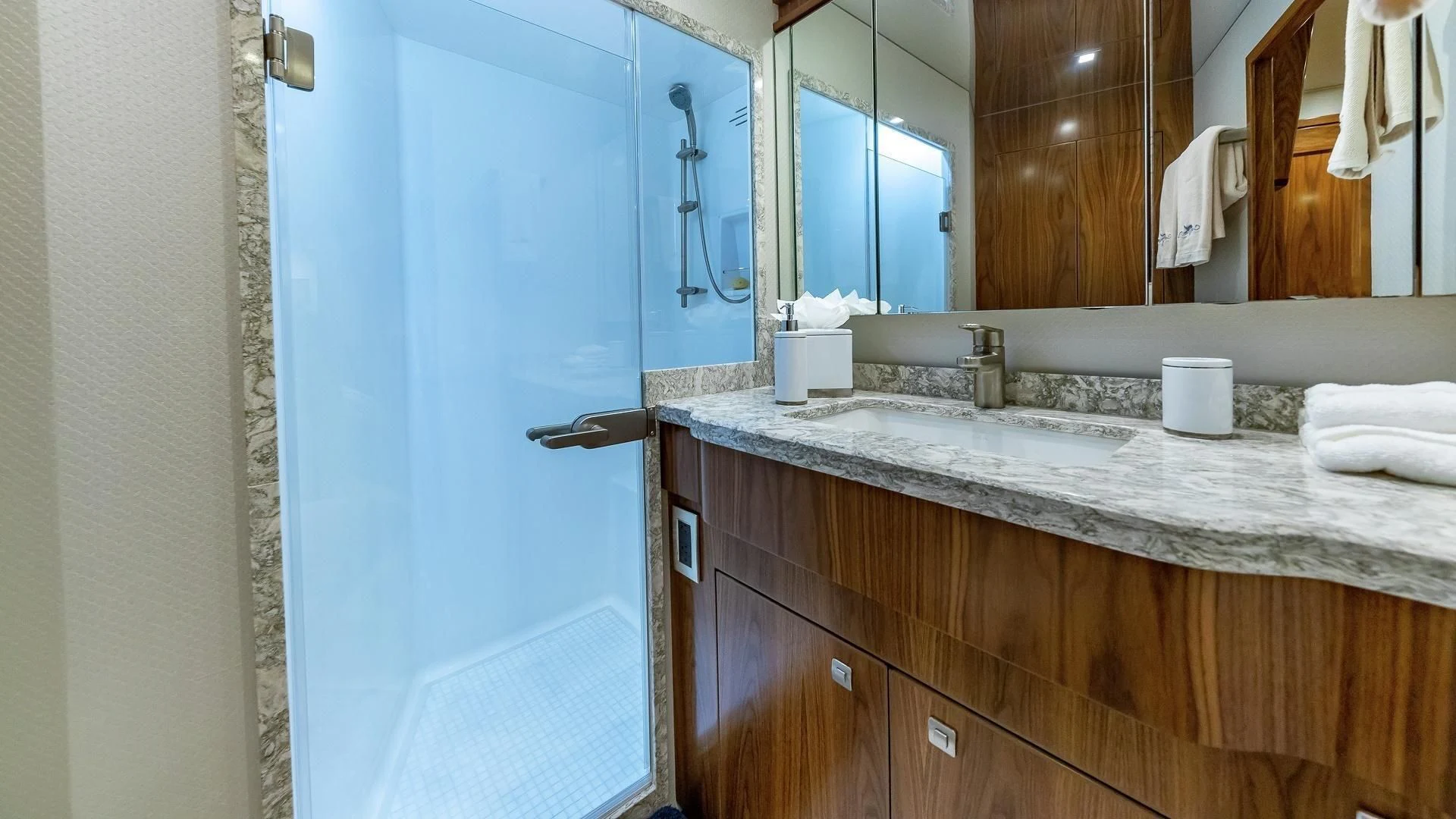 a bathroom with a countertop sink and mirror aboard AUSSIE RULES Yacht for Sale