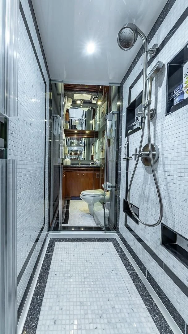 a bathroom with a glass shower aboard AUSSIE RULES Yacht for Sale