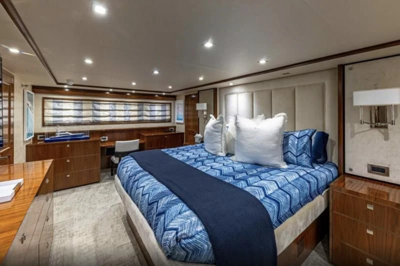 a bedroom with a bed and a desk aboard AUSSIE RULES Yacht for Sale