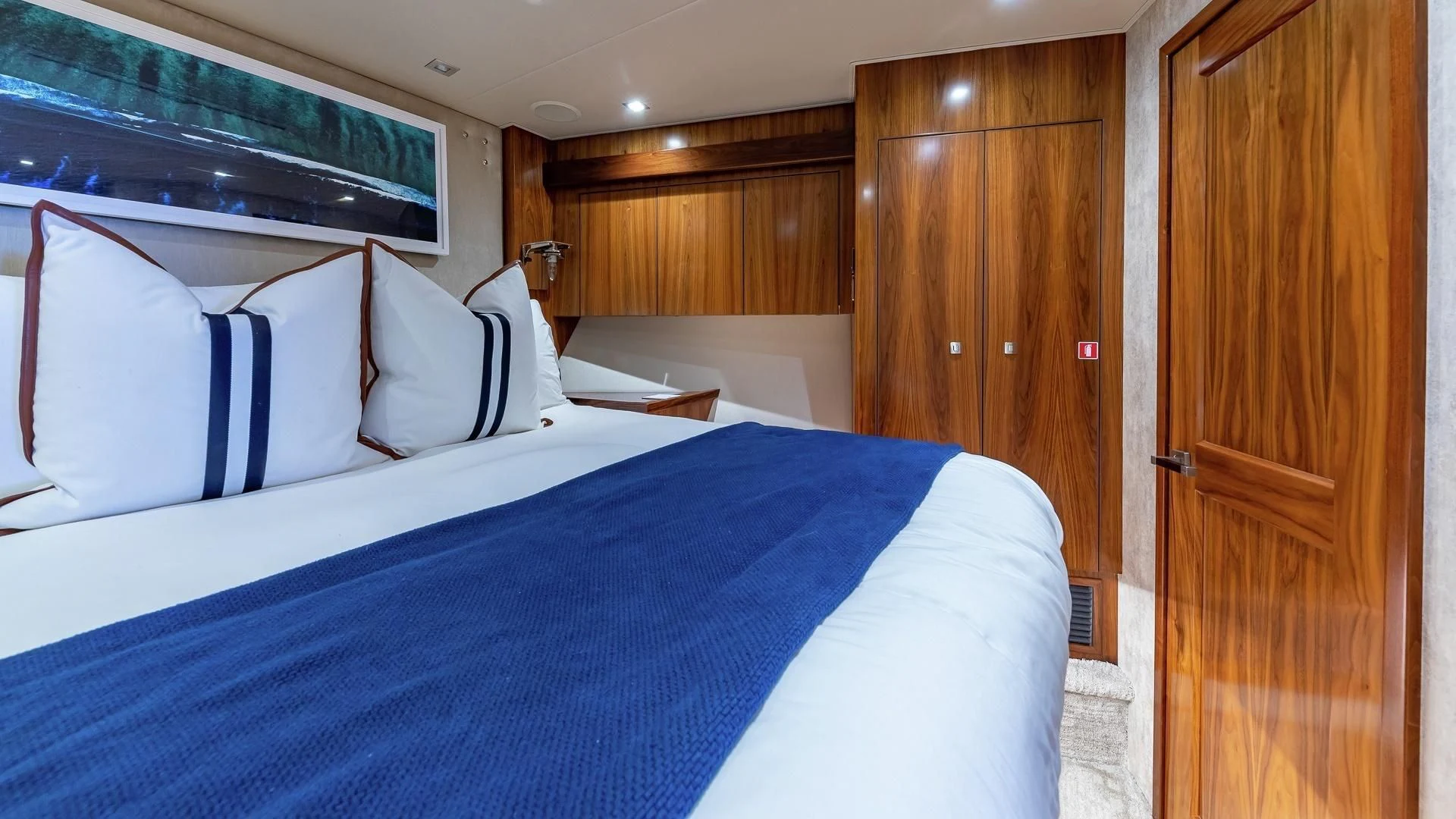 a bed with blue sheets aboard AUSSIE RULES Yacht for Sale