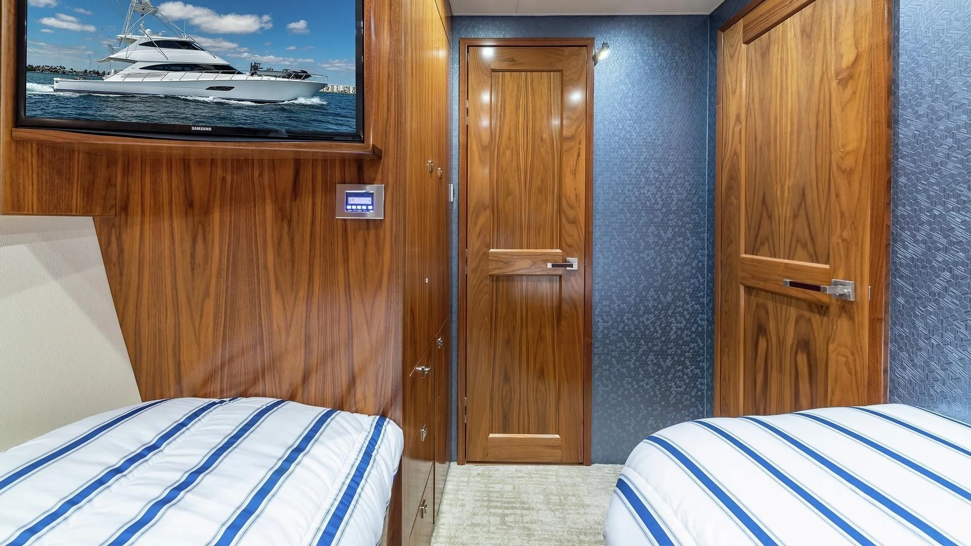 a room with a bed and a wood door aboard AUSSIE RULES Yacht for Sale
